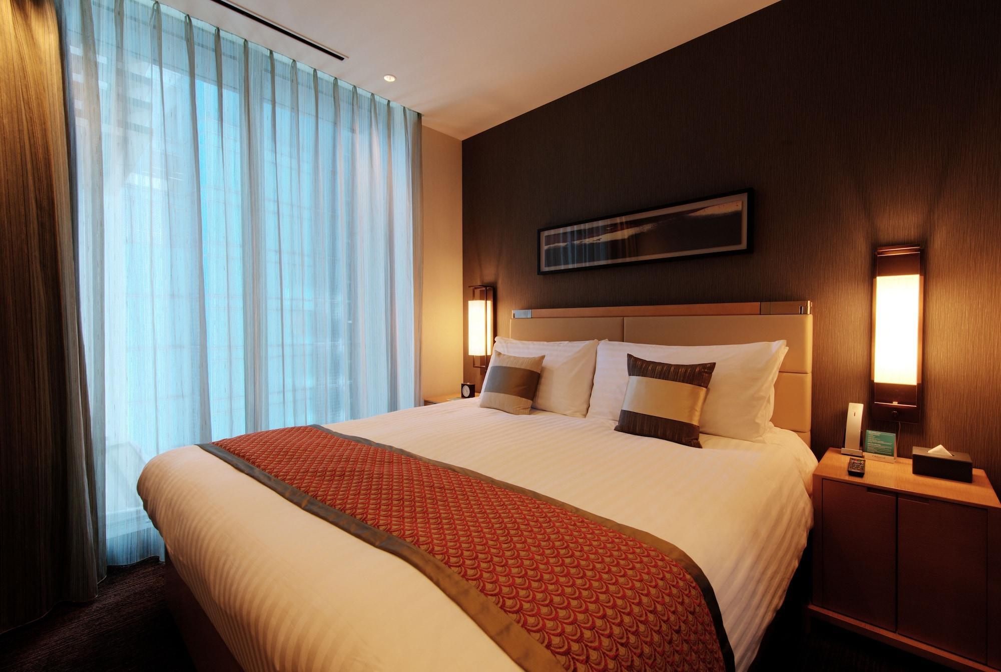 Oakwood Premier Tokyo Hotel Kültér fotó A bedroom in a hotel